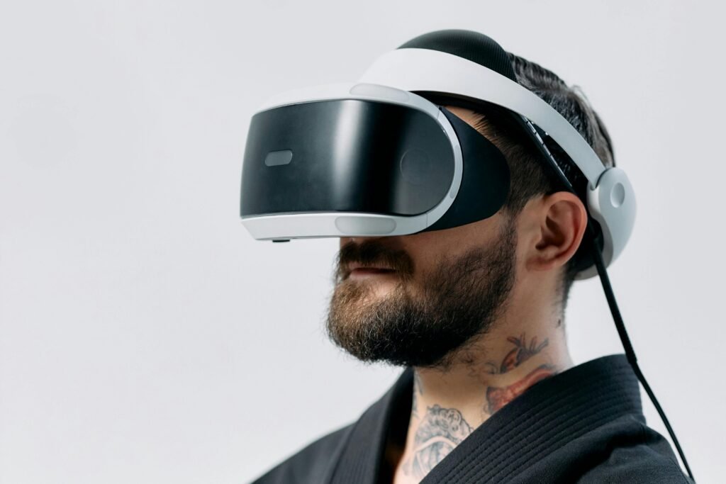 A man with a beard using a VR headset, showcasing modern technology in a studio shot.